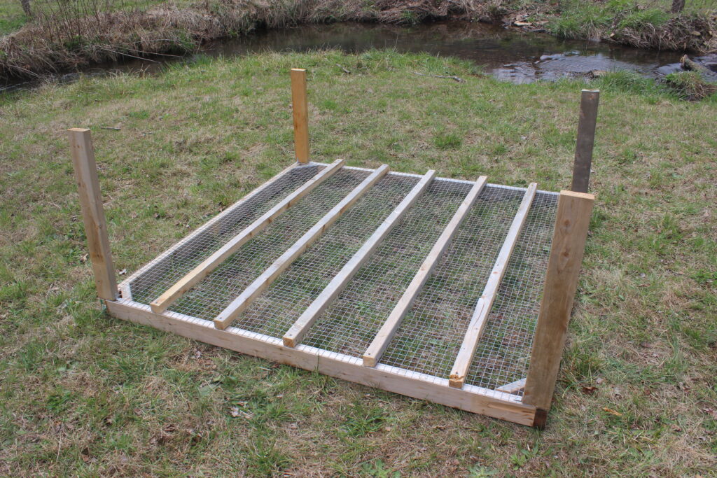 Adding corner posts to a mobile chicken coop.