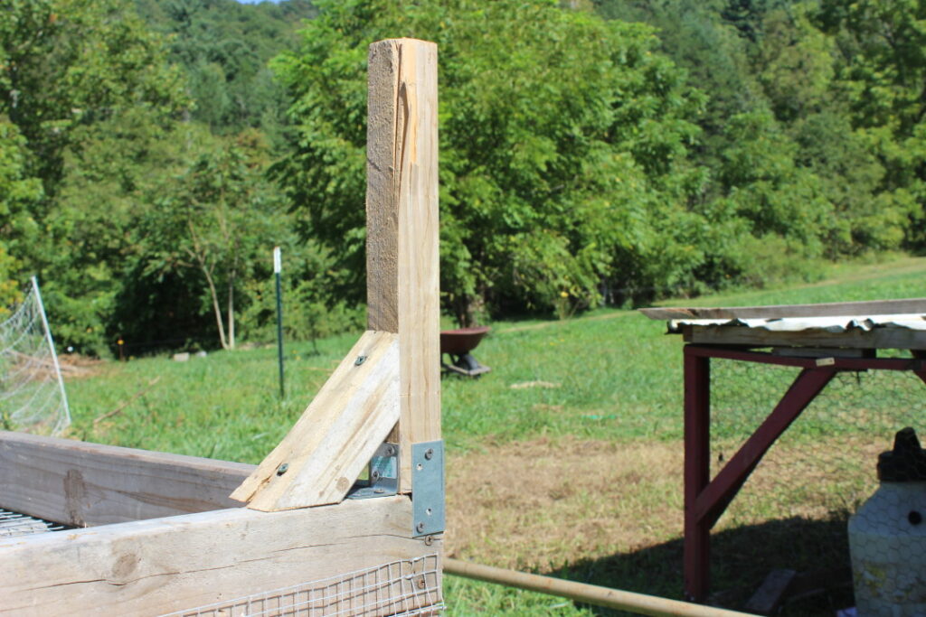 Adding legs to a mobile chicken coop.