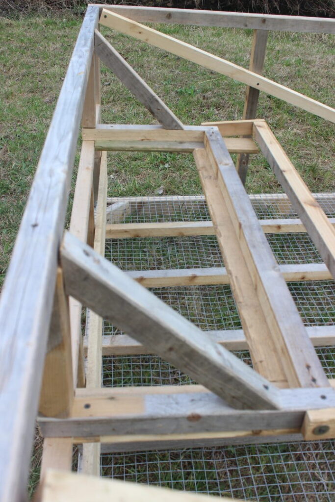 Adding nesting area braces to a mobile chicken coop.