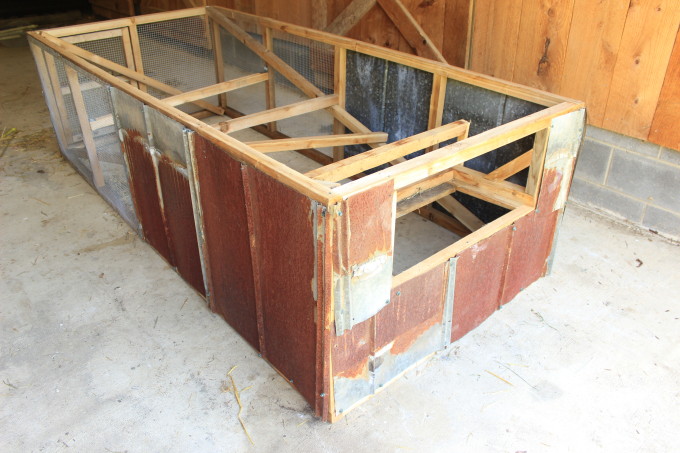 Adding side panels to a mobile chicken coop.
