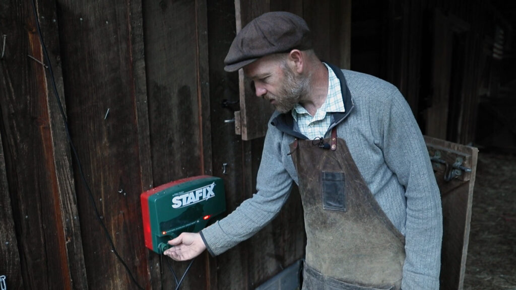 A man adjusting a Stafix electric energizer.